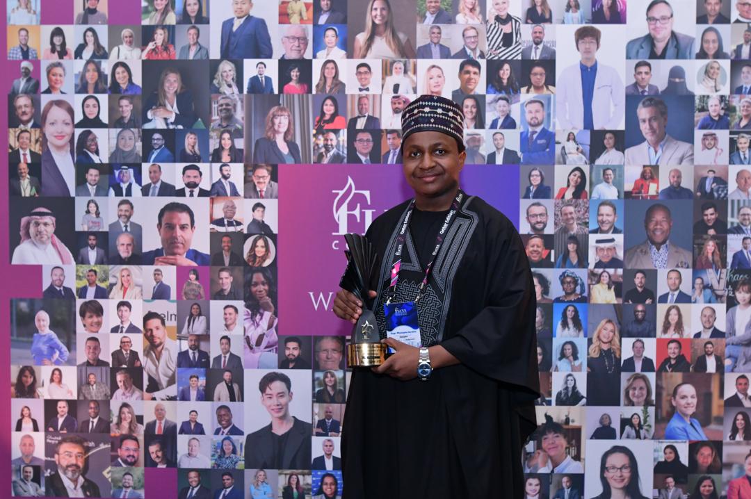 Mustapha Ibrahim holding an award